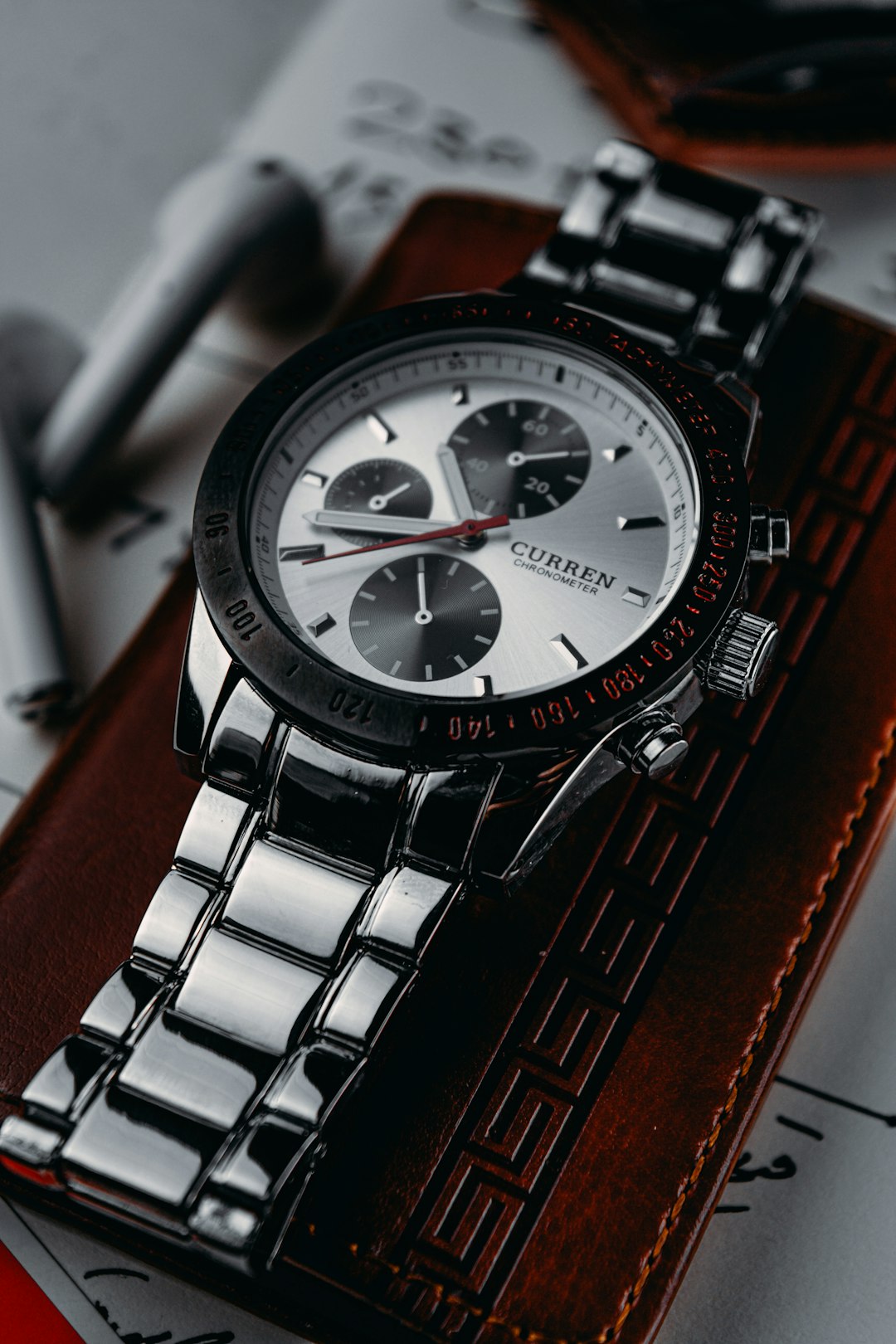 silver and black round chronograph watch