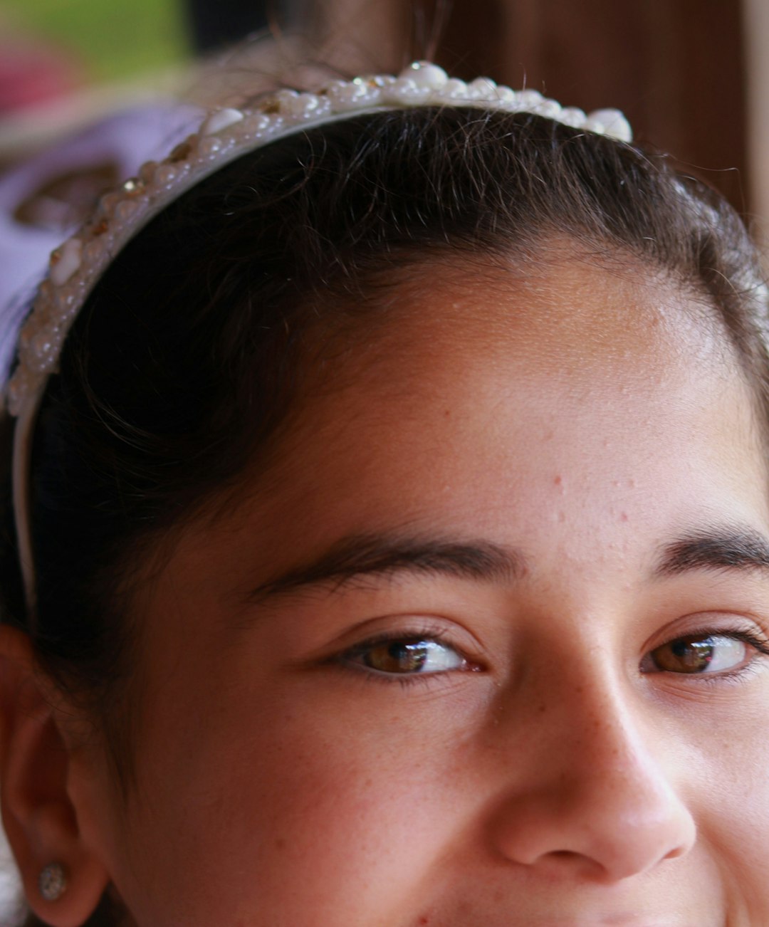 woman with black hair and white floral headband