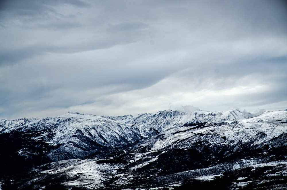 snow covered mountain under cloudy sky during daytime