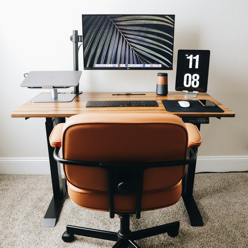 black flat screen computer monitor on brown wooden desk