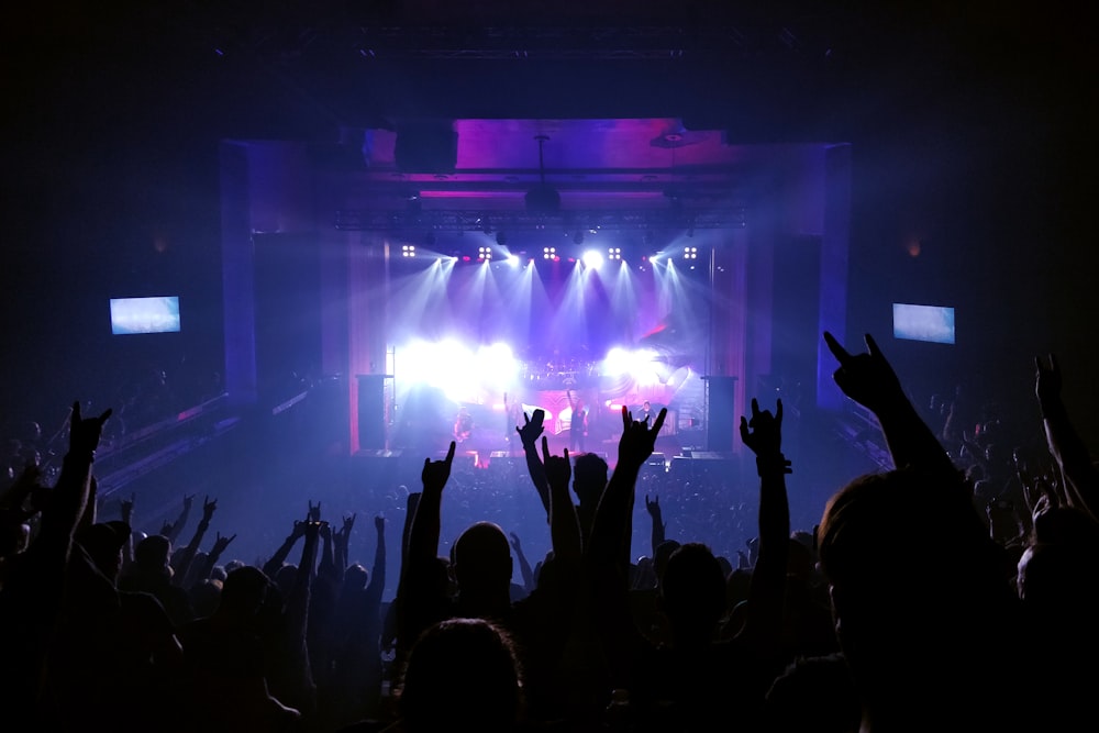 people standing on stage with lights