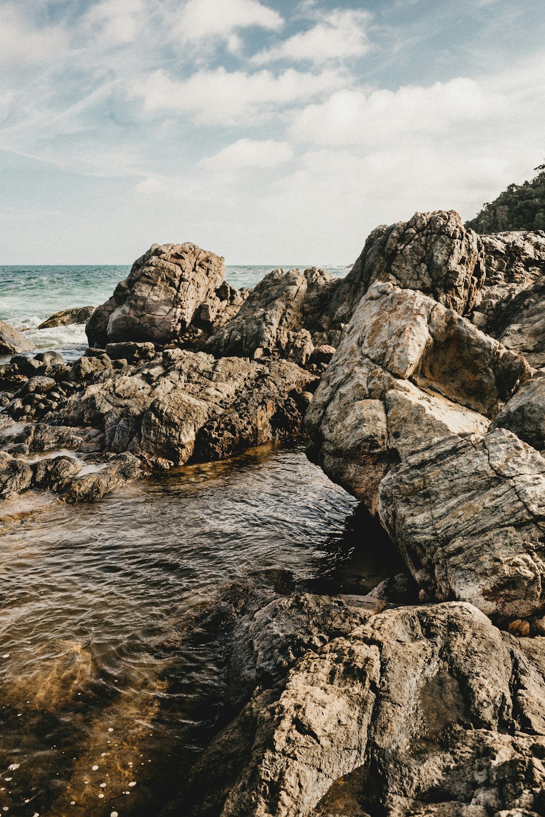 brown rock formation on sea during daytime