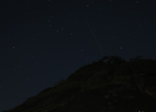 black mountain under blue sky during night time