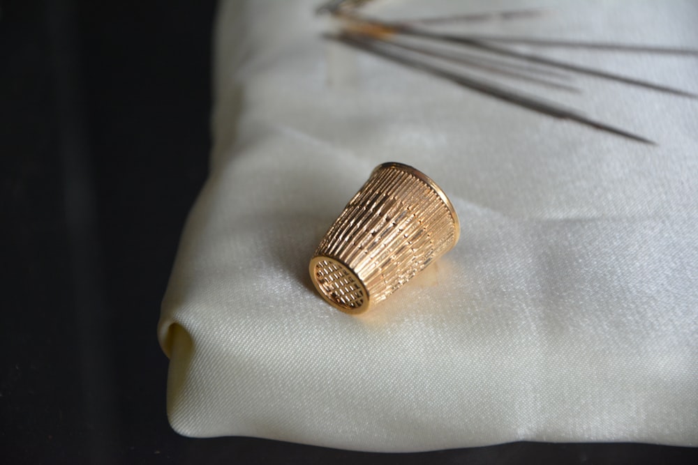 silver ring on white textile