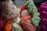 Bundles of vibrant thread in various colors are closely piled together. The threads are neatly wound into skeins, exhibiting a mix of textures.