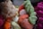Bundles of vibrant thread in various colors are closely piled together. The threads are neatly wound into skeins, exhibiting a mix of textures.
