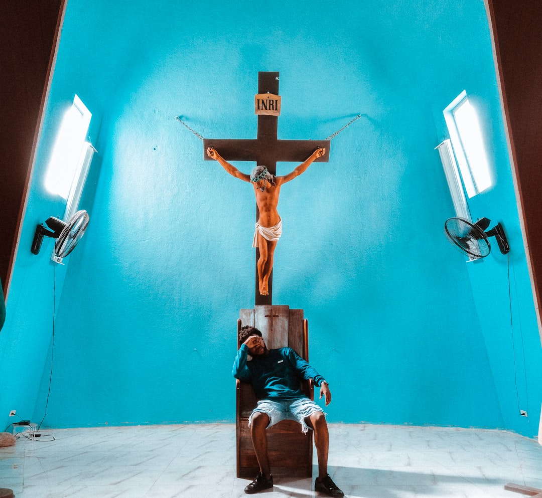 brown wooden cross on blue wall