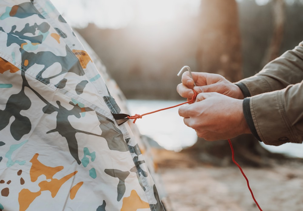 person holding red and white stick