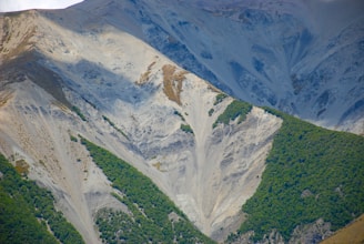 green and white mountains under white sky during daytime