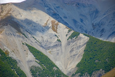 green and white mountains under white sky during daytime