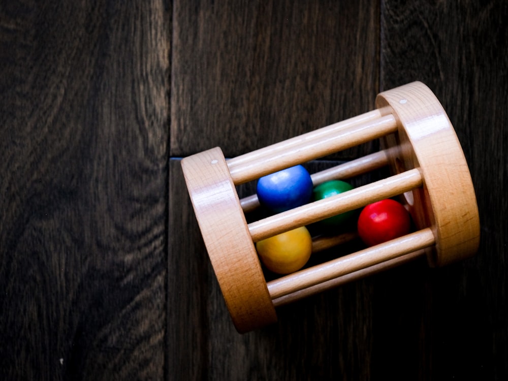 red blue and yellow beads in brown wooden container