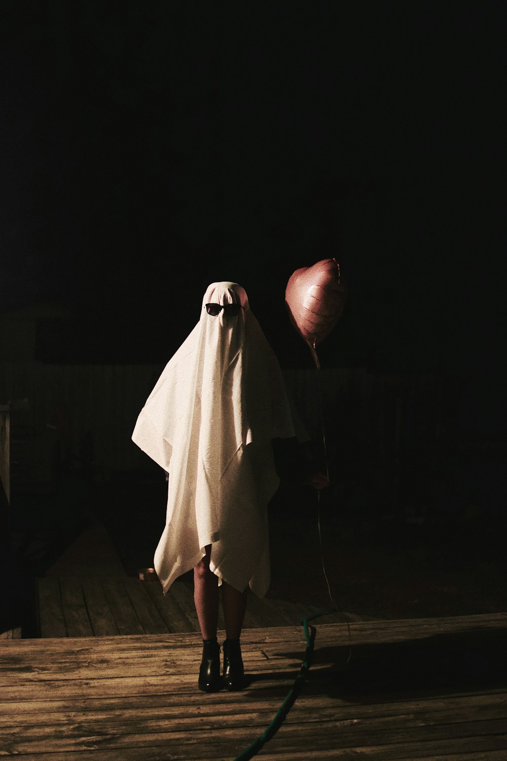 person in white robe standing on brown wooden floor