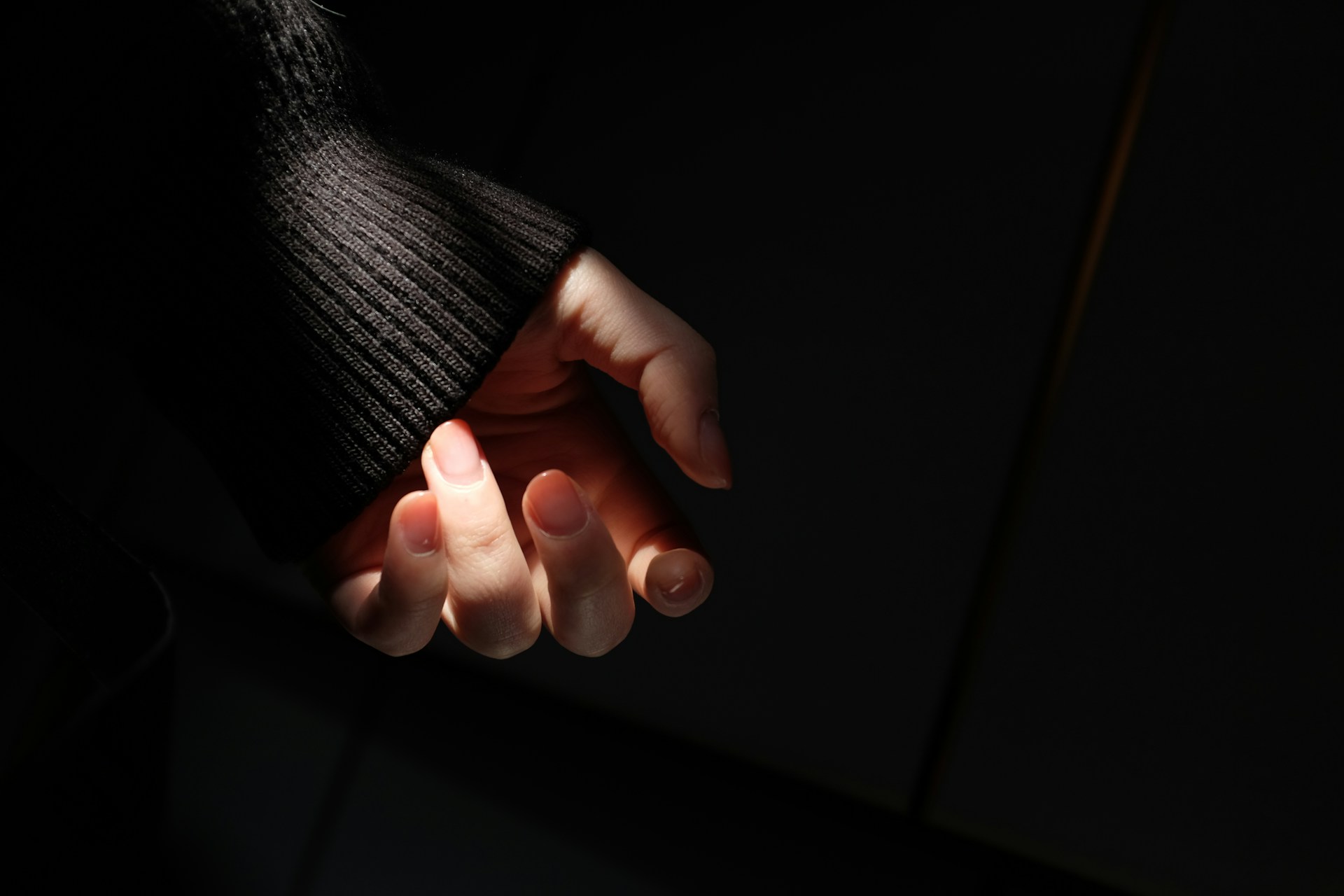 persons hand with orange manicure