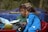 woman in blue jacket sitting beside woman in green shirt