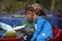 woman in blue jacket sitting beside woman in green shirt