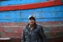 man in black leather jacket wearing white cap