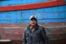 man in black leather jacket wearing white cap