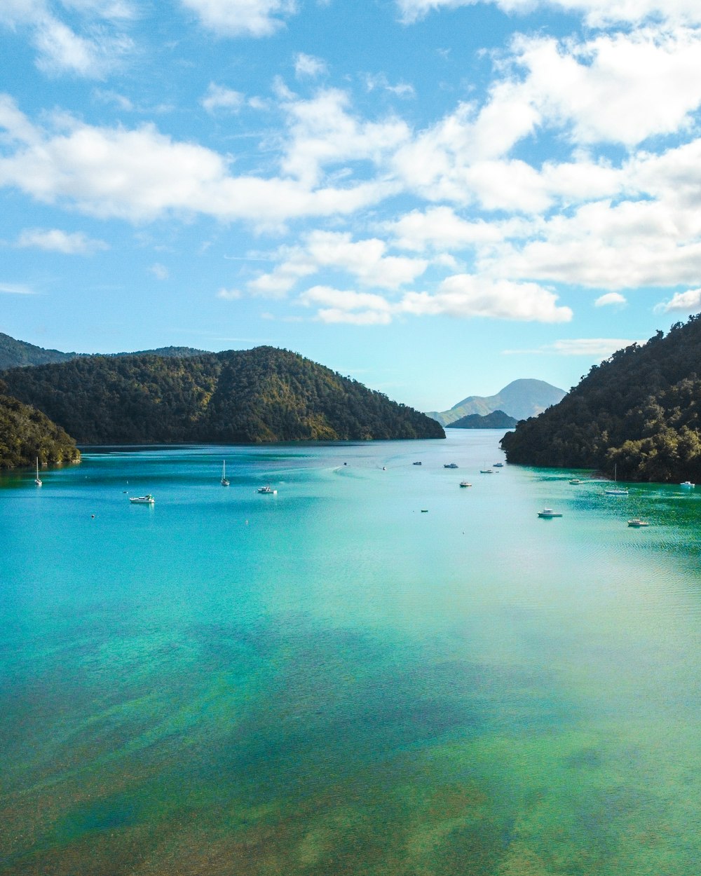 body of water near mountain during daytime