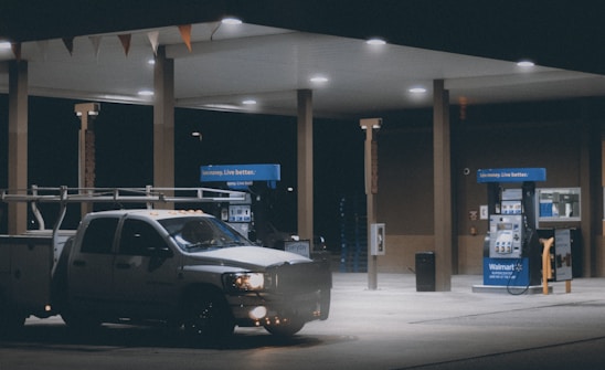 A professional fuel delivery truck parked at an industrial site during sunset, showing reliability and energy.