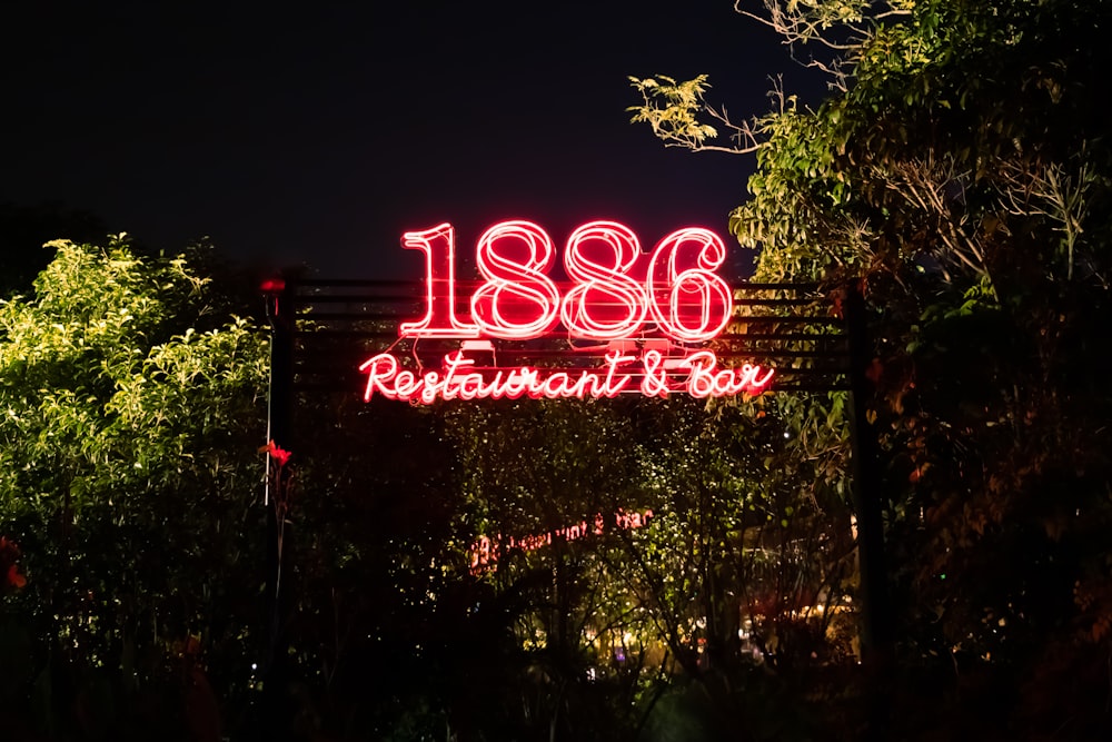 a restaurant sign is lit up at night