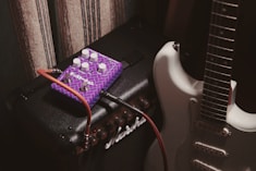 purple and white electric guitar