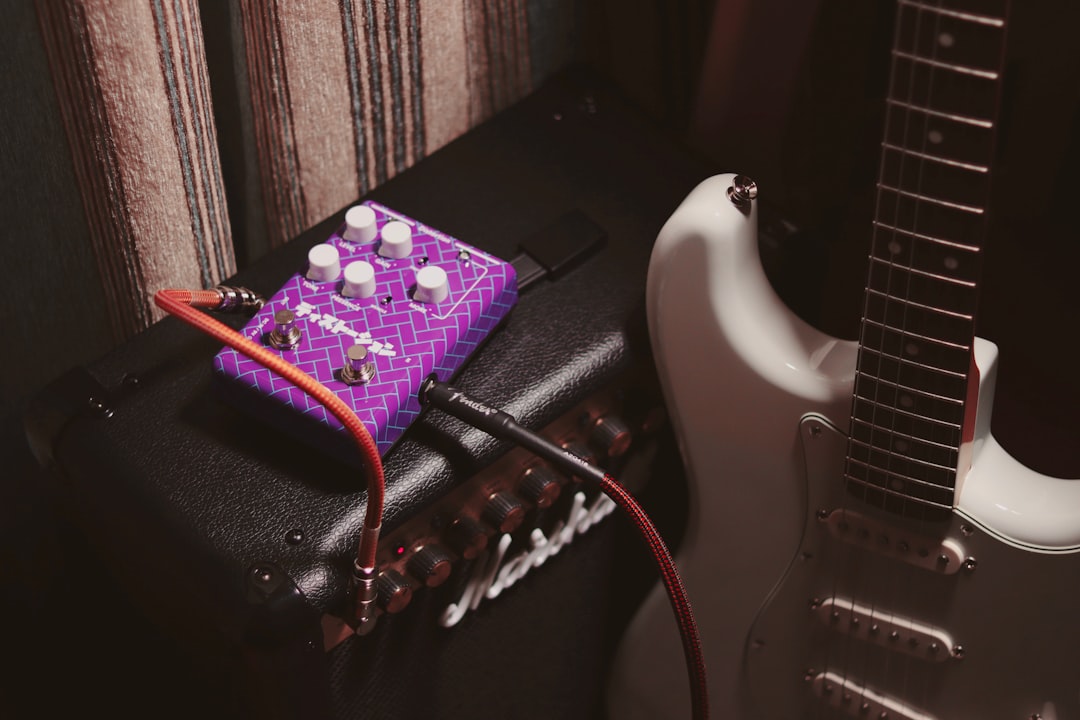purple and white electric guitar