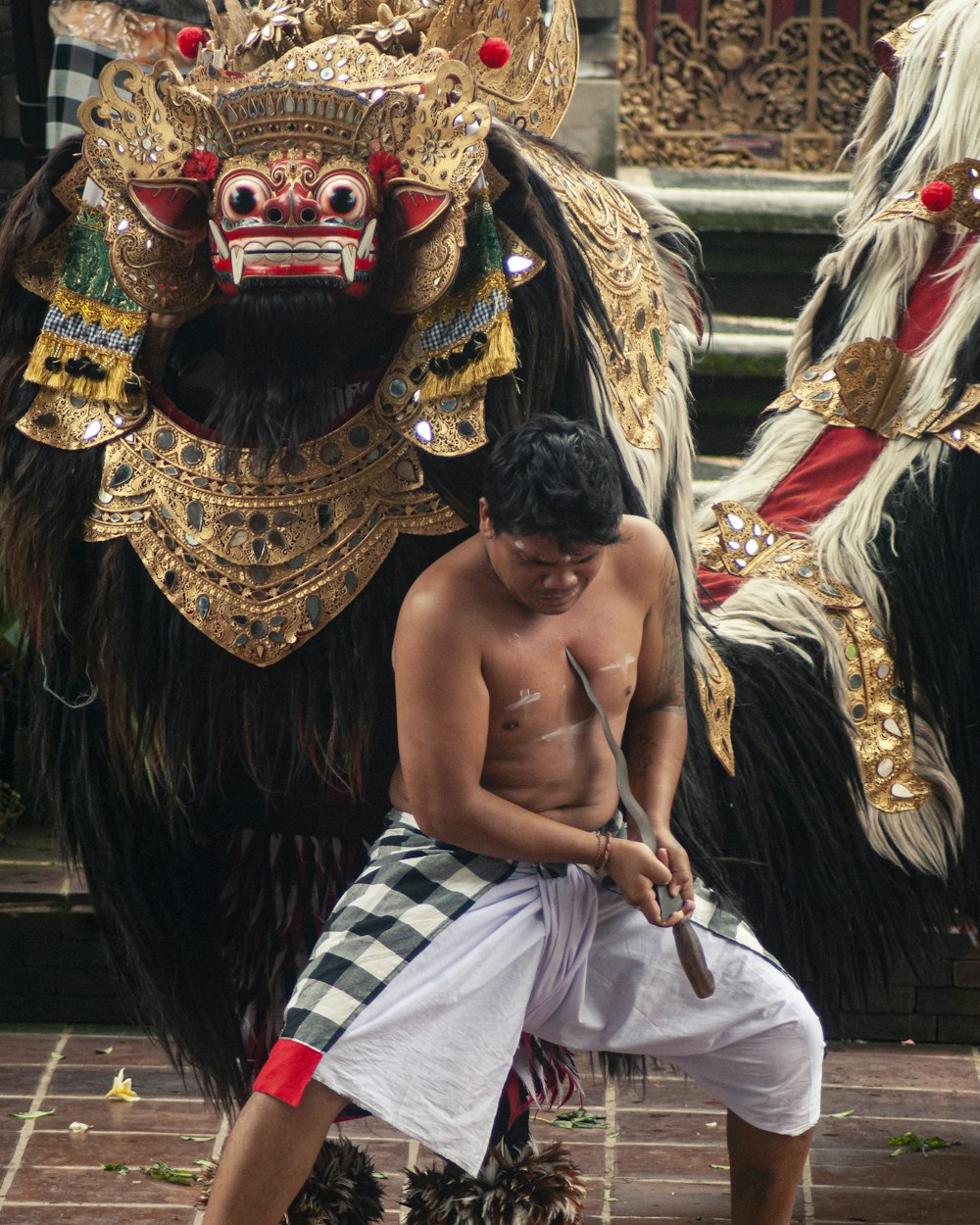 woman in white and red skirt with gold mask