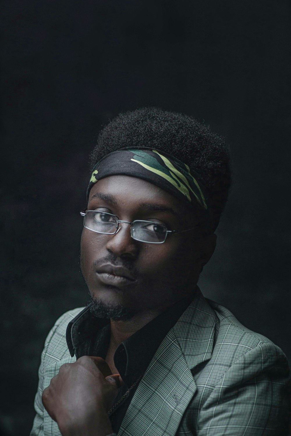 man in black framed eyeglasses and green knit cap