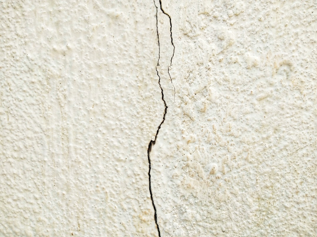 black coated wire on white concrete wall