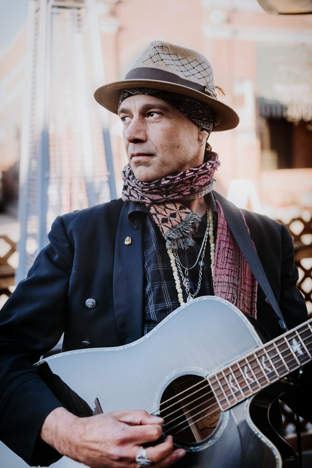 man in black coat playing guitar