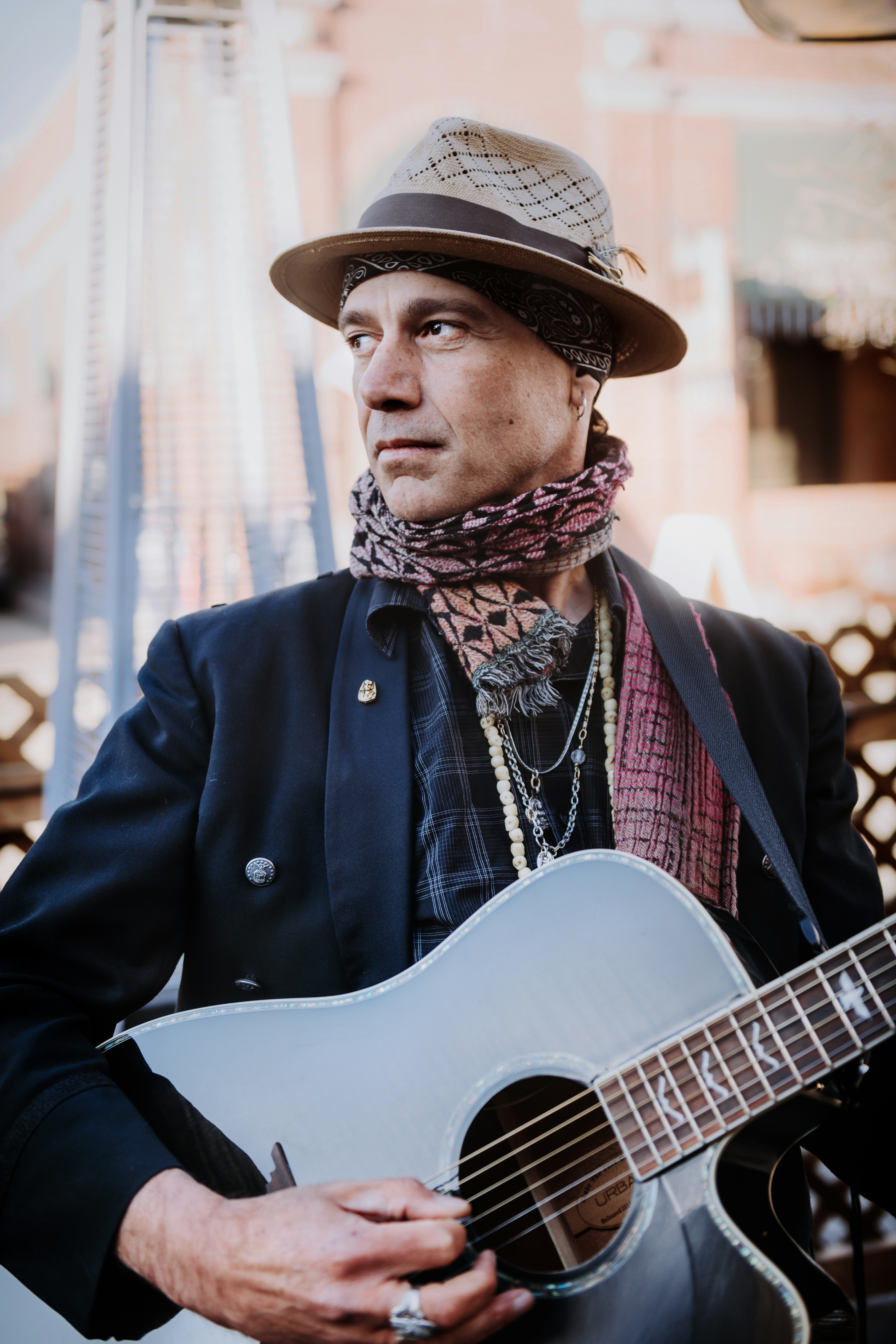 man in black coat playing guitar