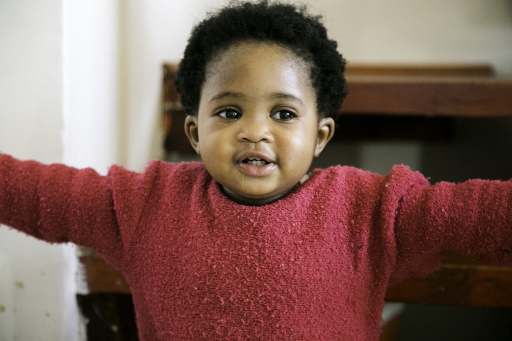 boy in red crew neck sweater