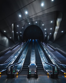 black and blue escalator in a tunnel