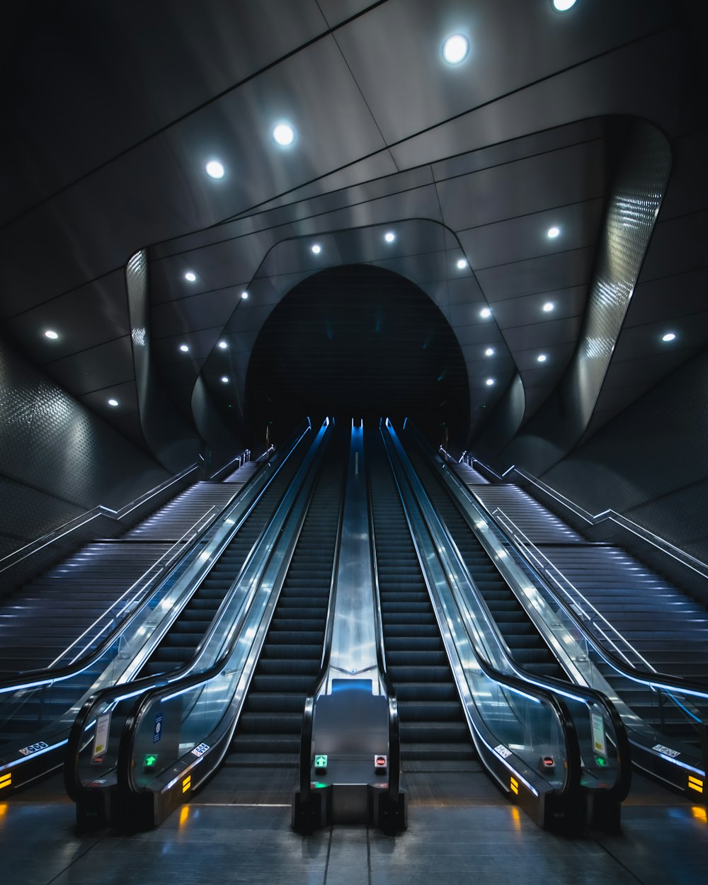black and blue escalator in a tunnel