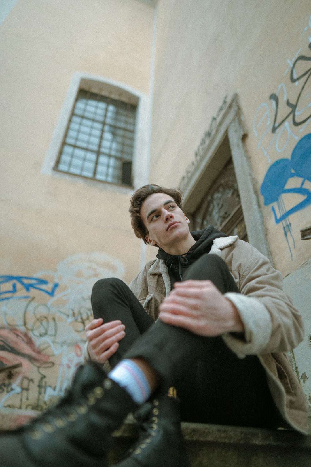 woman in black jacket sitting beside man in beige coat