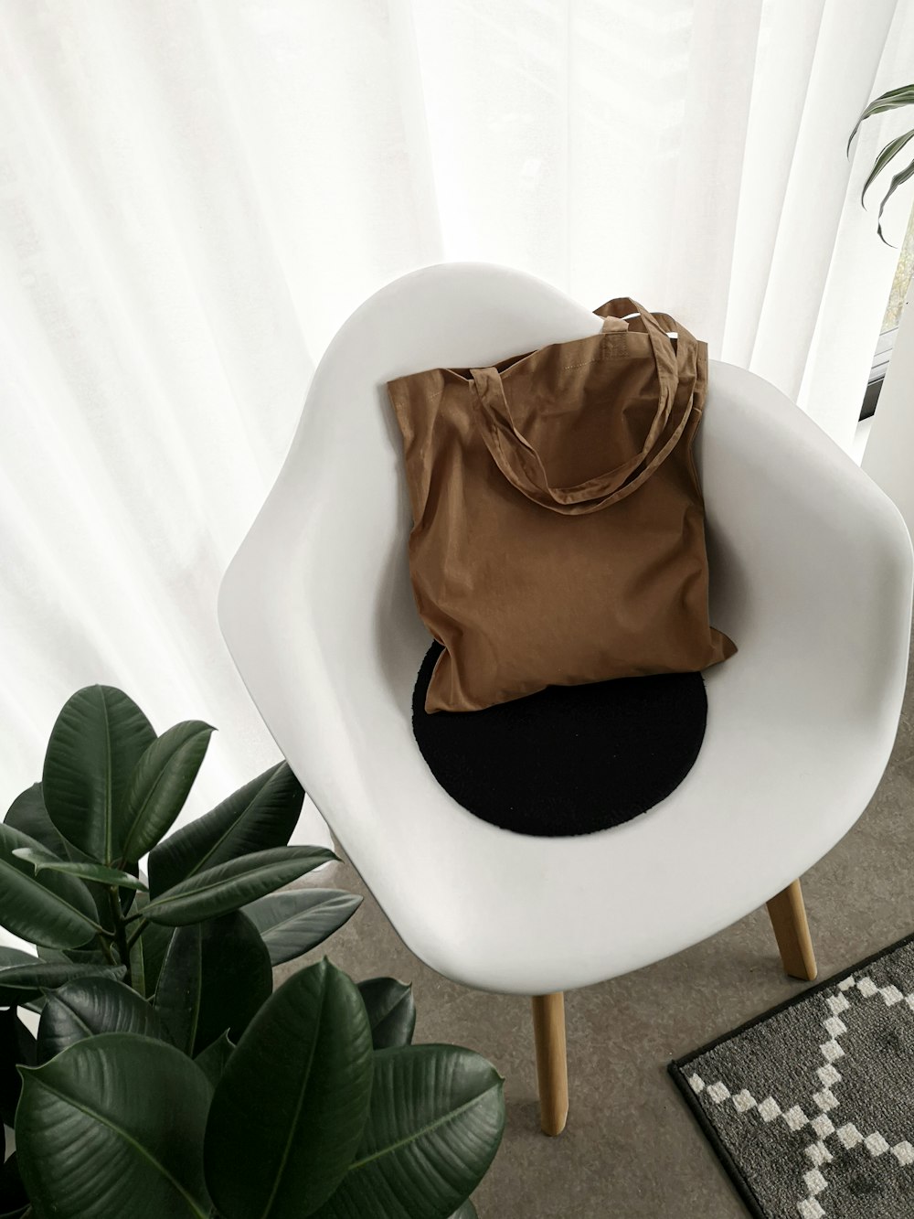 brown and black textile on white chair
