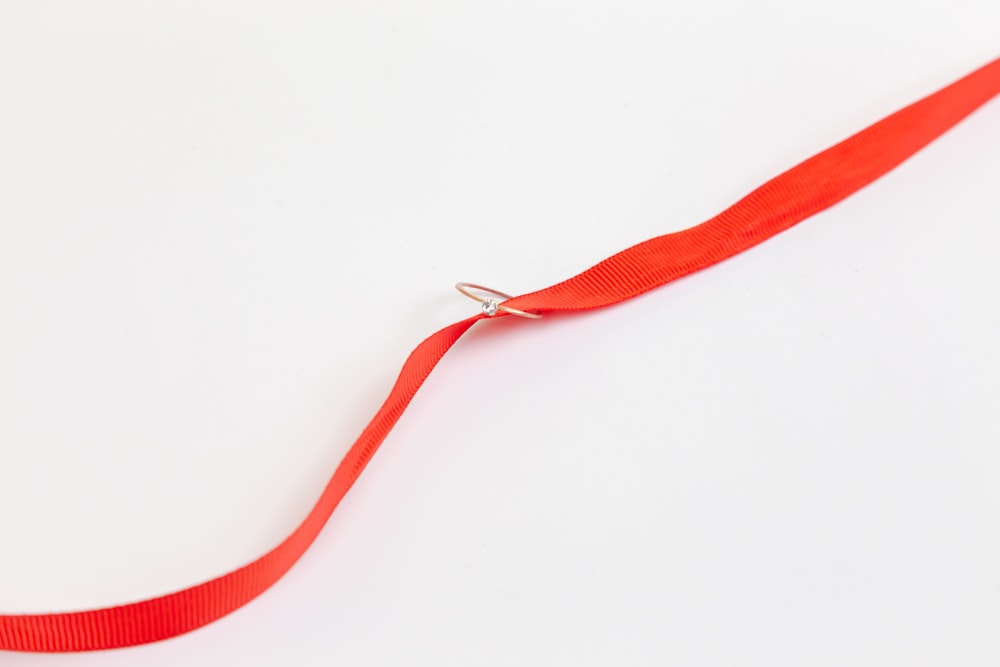 bracelet rouge sur surface blanche