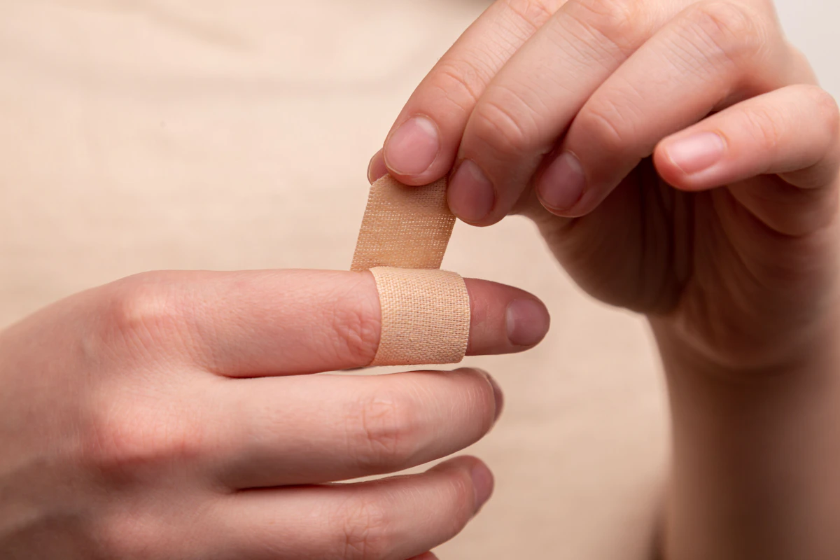 Adhesive plaster applied to a finger, representing first aid and post-treatment skin recovery