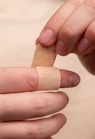 person with band aid on middle finger