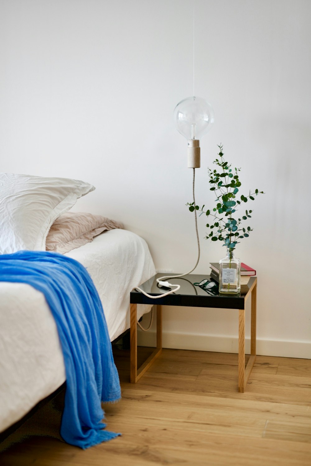 white and silver table lamp on brown wooden side table