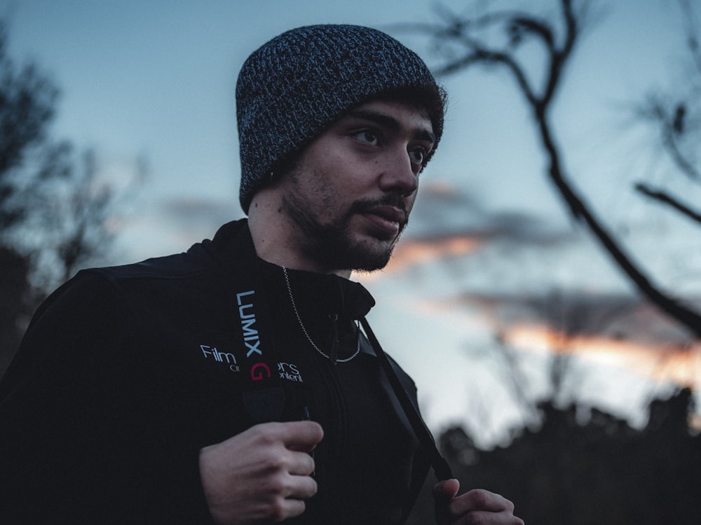 man in black knit cap and black jacket