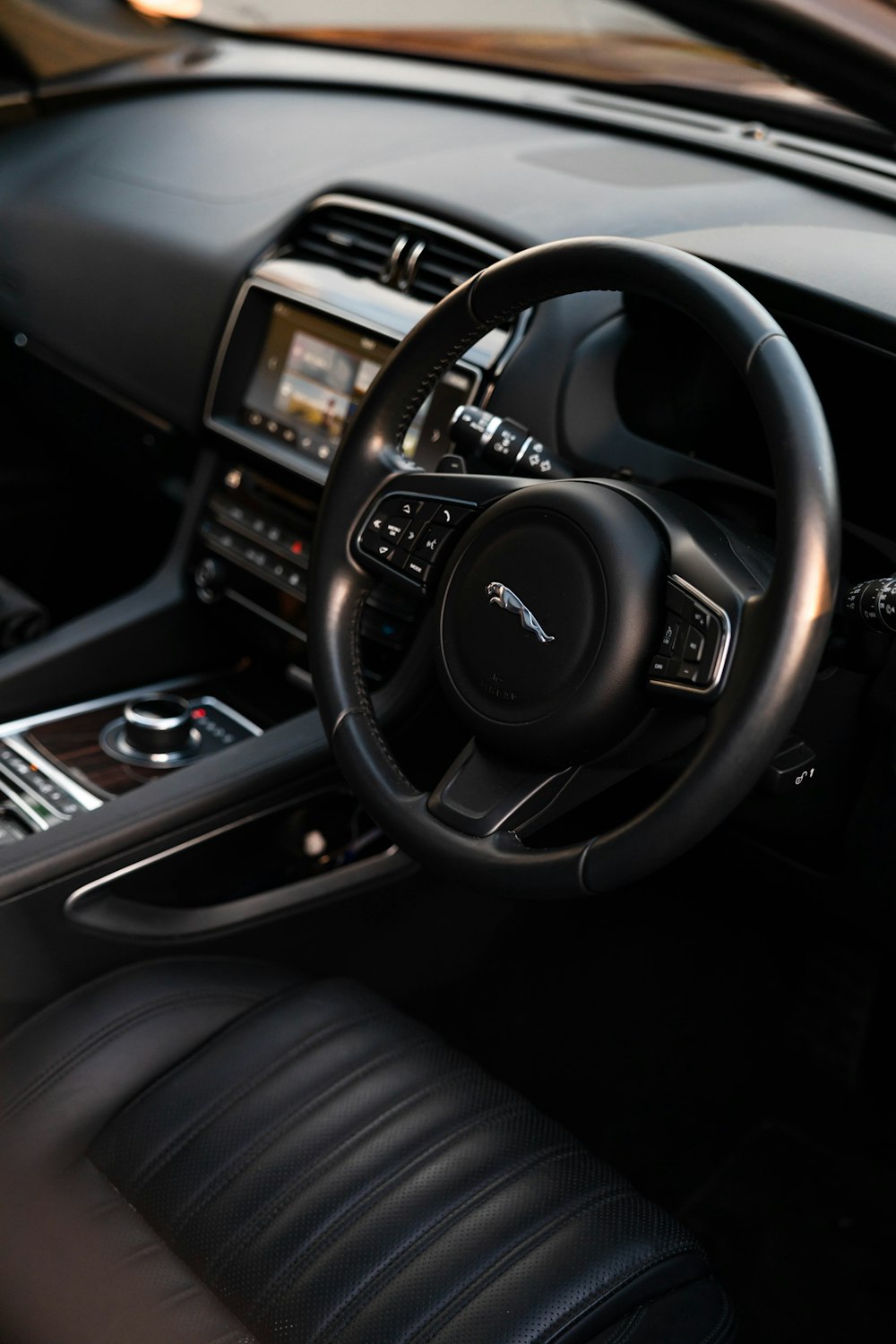 the interior of a car with a steering wheel and dashboard