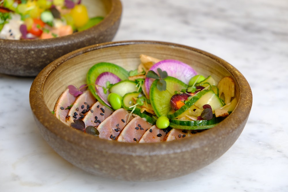 sliced vegetables on brown wooden bowl