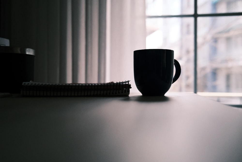 blue ceramic mug on white table