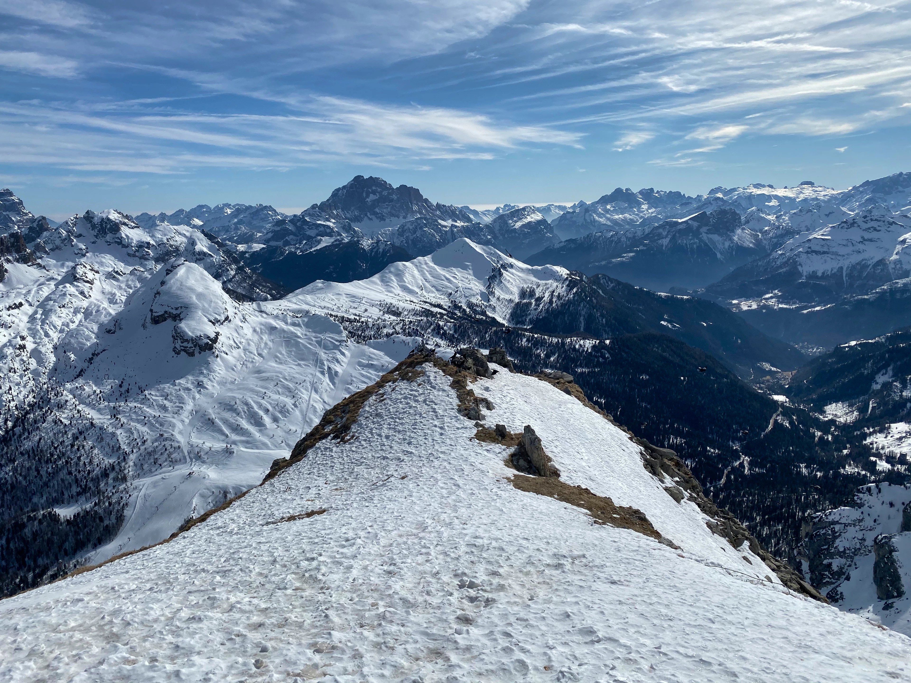 Snow-covered Dolomites above Cortina d'Ampezzo under a blue sky
