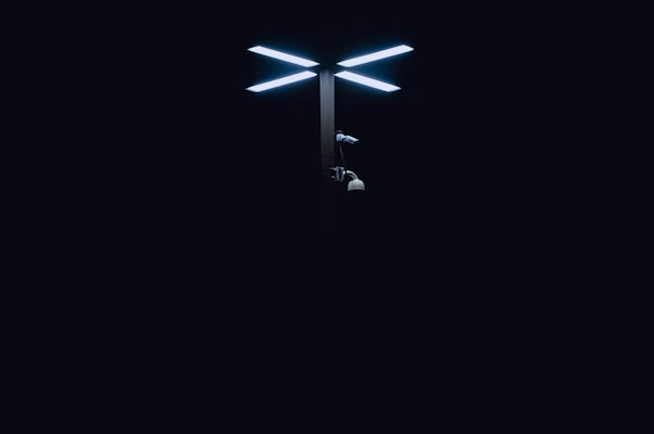 A modern LED light pole casting bright, energy-efficient light over a parking lot.