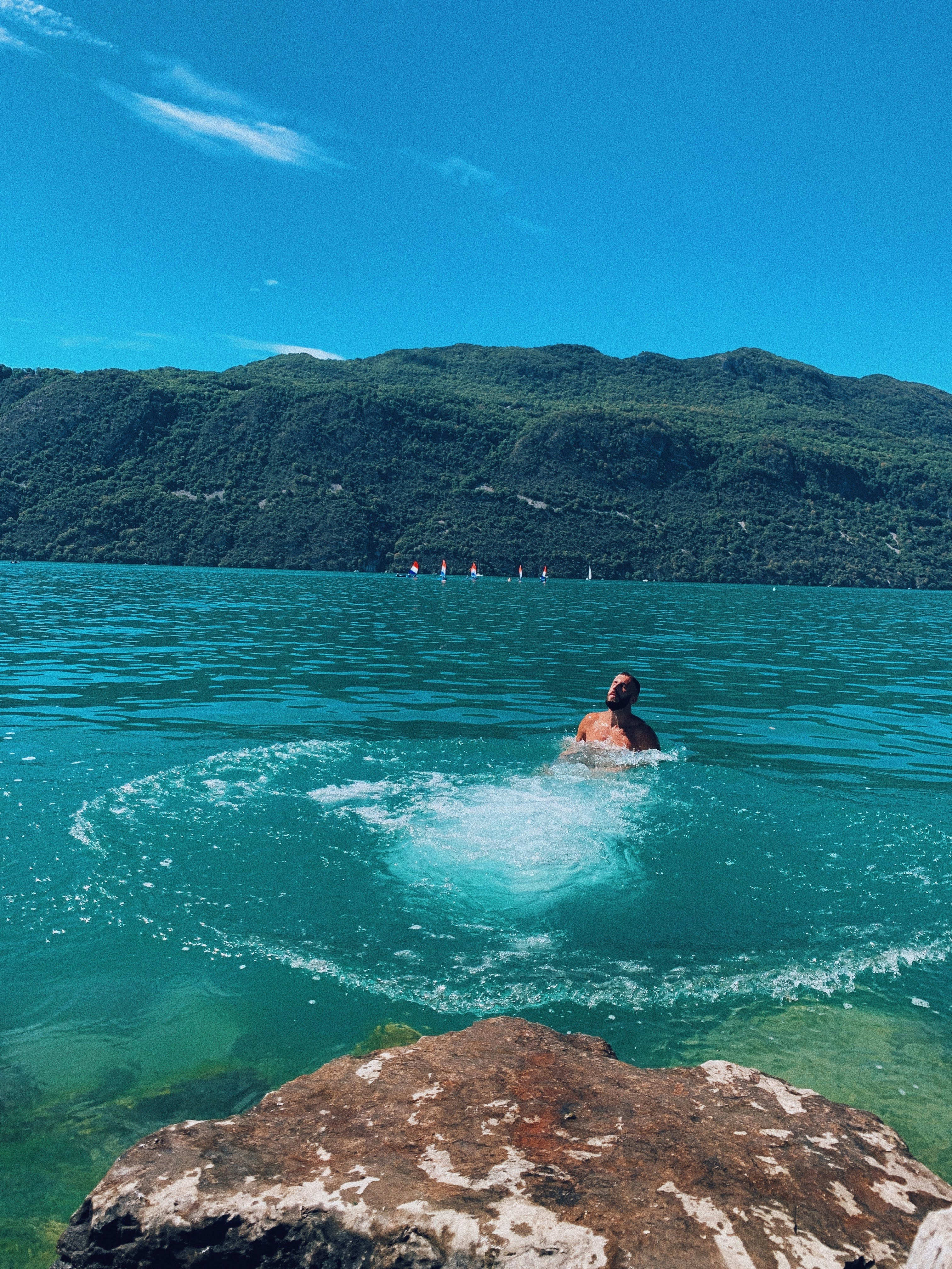 woman in black bikini swimming on water during daytime
