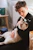 A friendly veterinarian examining a relaxed cat in a warm, welcoming clinic room.