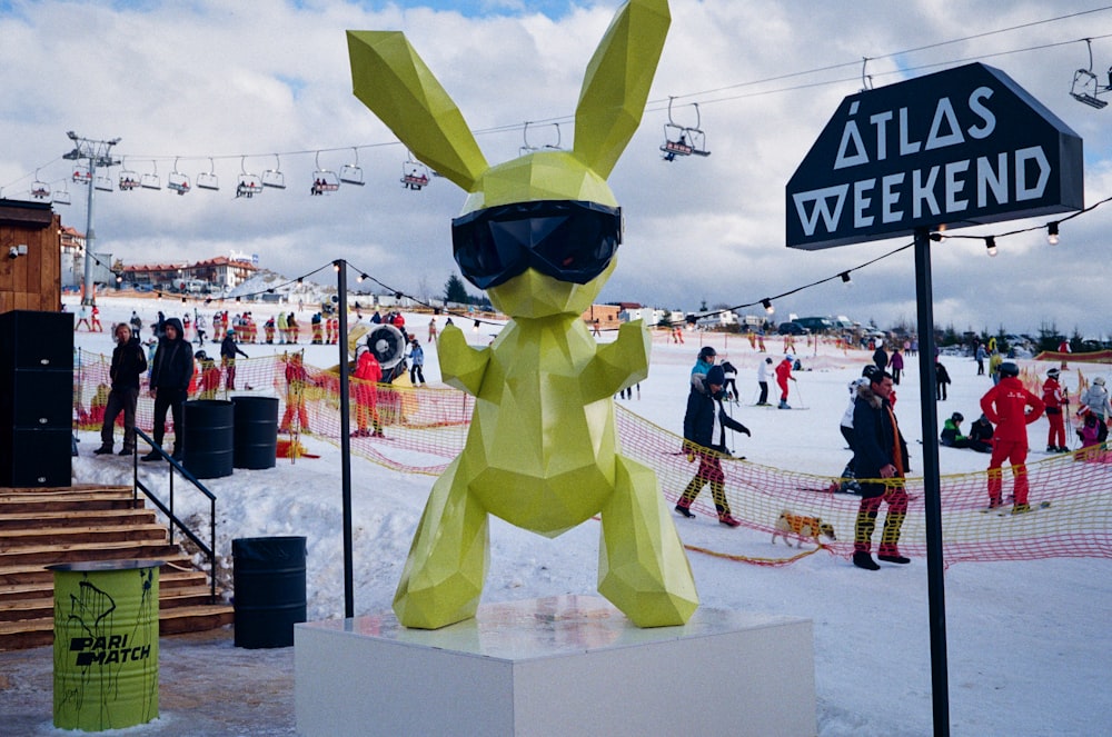 yellow and black bird mascot standing on ice field during daytime