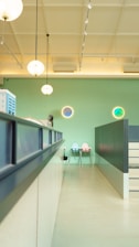 Modern clinic interior with clean, professional design featuring light green and gold accents.